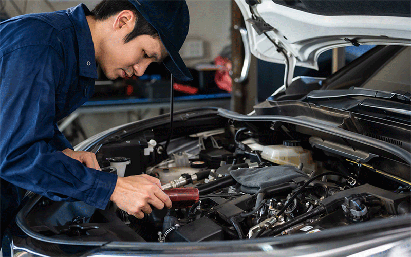 車のフロント部を整備する男性